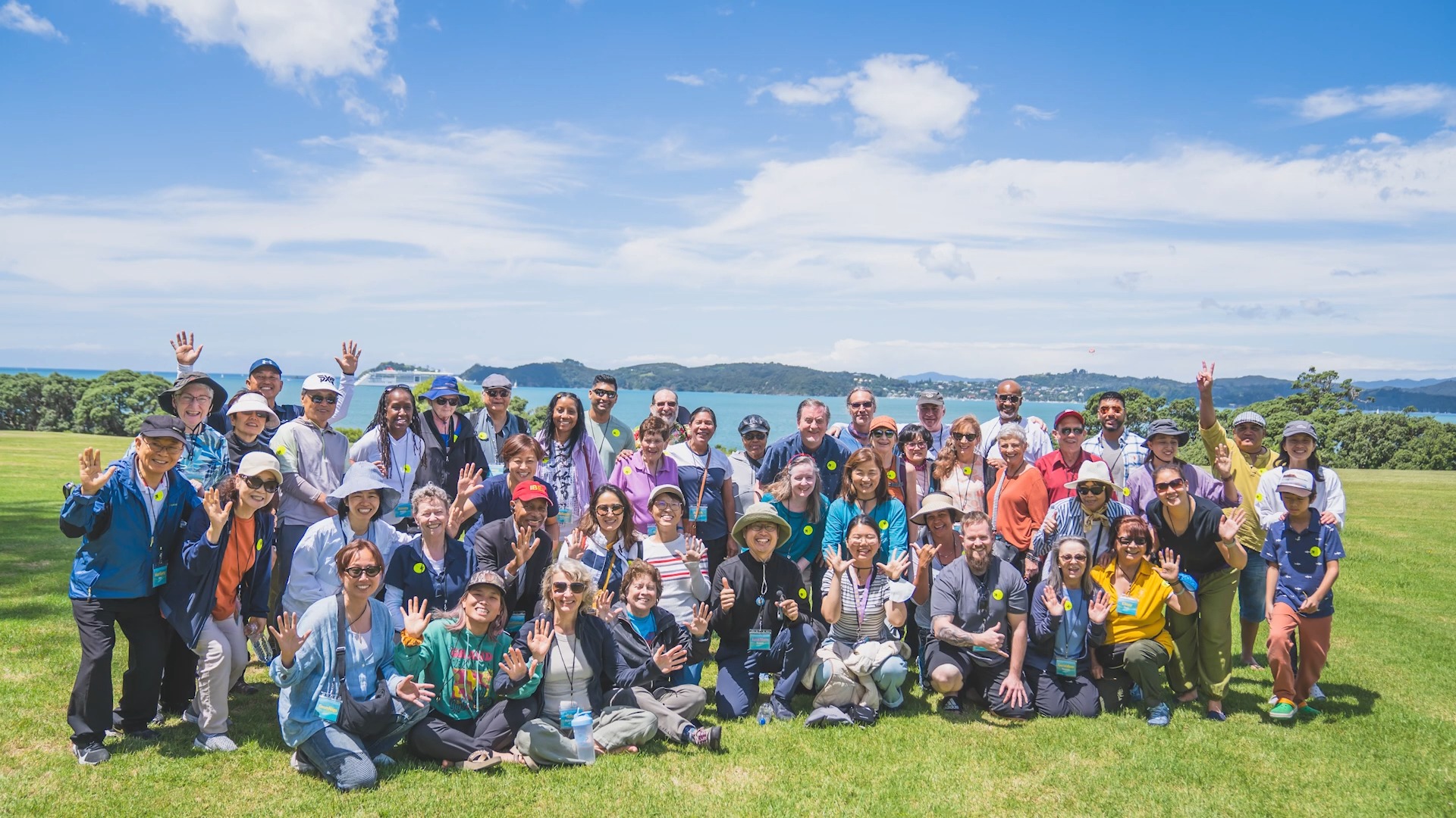 New Zealand meditation tour group gathered on a sunny hilltop